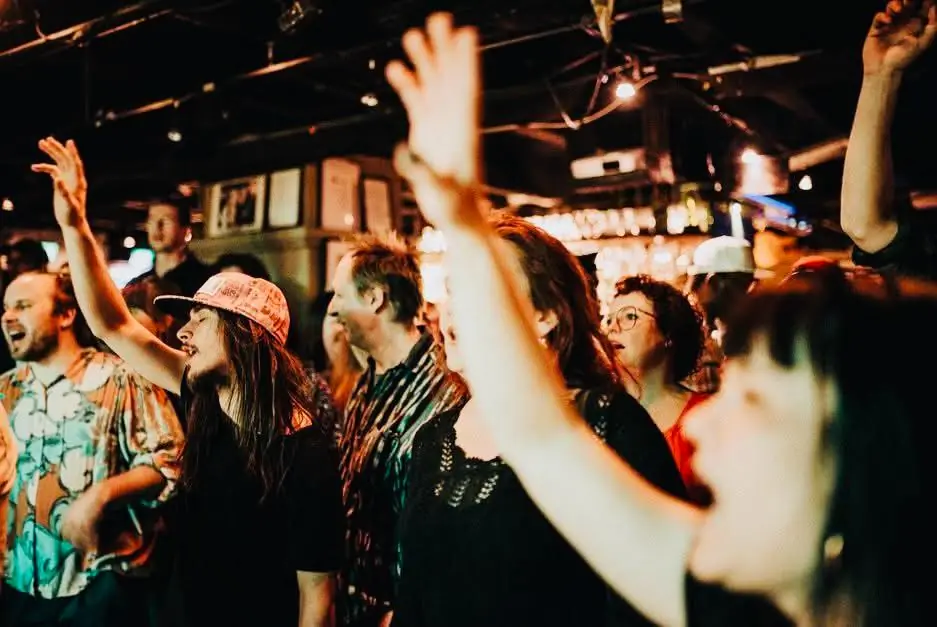 Dancers throw their hands in the air at an Afrobeat night